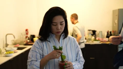 Handheld shot of a man grinding pepper on the drink Stock Footage 114884591
