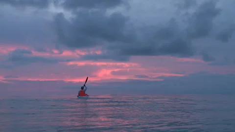 Handheld shot of a man kayaking Stock Footage 310540015