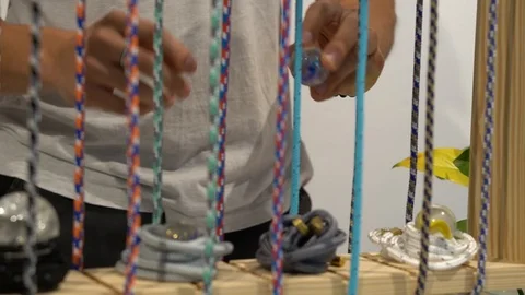 Handheld shot of man looking at craft jewellery at shore Stock-Footage 114849610