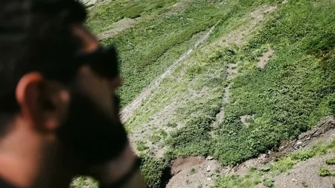 Handheld shot of man looking at the mountain while travelling on ski lift Stock Footage 122519684