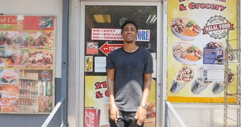 Handheld shot of man standing and rapping in front of shop Stock Footage 120149313
