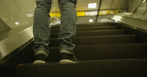 Handheld shot of man standing on escalators then leaving and walking away, Japan Stock Footage 124720565
