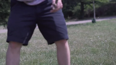 Handheld shot of man trying to remove stick from mouth of pet dog while playing Stock Footage 114878170