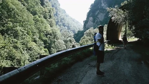 Handheld shot of man walking on mountain trail Stock Footage 122519386