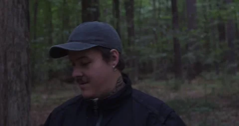 Handheld shot of a man in the woods capturing nature with his smartphone. Stock Footage 313949102