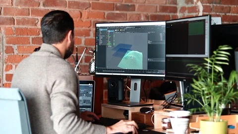 Handheld shot of man working with 3D software at workstation Video stock 114879090