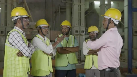 Handheld shot of manager or supervisor advising or assigning work to workers Stock Footage 172055784