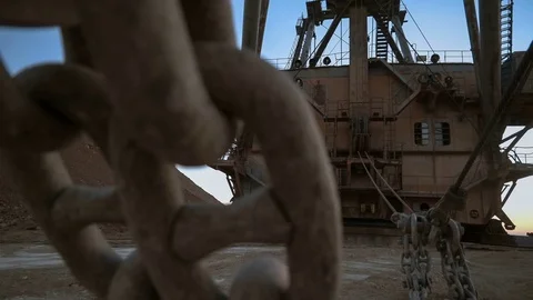 Handheld shot of massive bucket chain of dragline excavator standing on the side Stock Footage 75534241