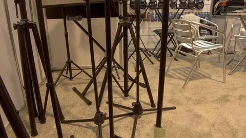 Handheld Shot of Microphone Stands and Audio Equipment at Trade Show Stock Footage 104885440