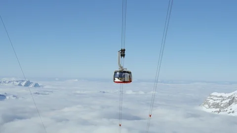 Handheld shot of modern cabin of cable railways travelling up Swiss mountains Stock Footage 129091891