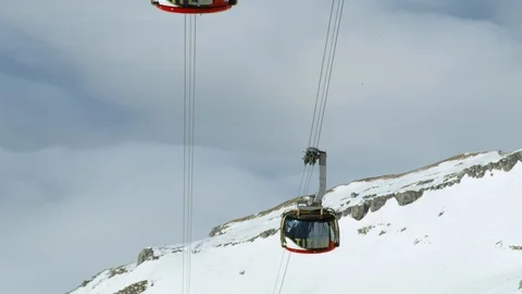 Handheld shot of modern cabins of cable railways used by tourists in Swiss Alps Stock Footage 129091635