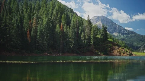 Handheld shot of Mountain Peak behind lake Stock Footage 127461277