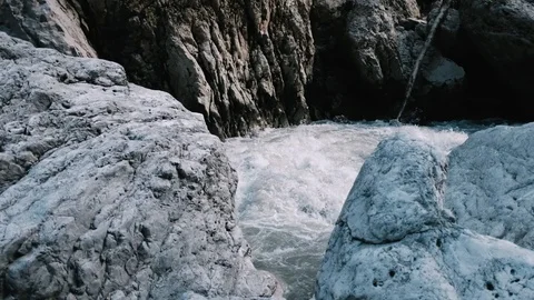 Handheld shot of mountain river flowing through the rocks Stock Footage 122403254