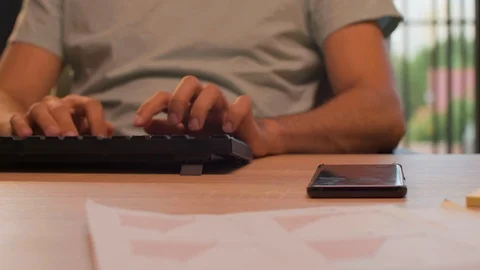 Handheld shot of office worker reaching out at the phone in warm orange sunset Stock Footage 114311425