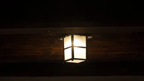 Handheld shot of old lantern light decor inside Bran Castle (aka Dracula's Video stock 119923188