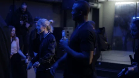 Handheld shot of people dance at dance club and enjoy drinks Video stock 114847321