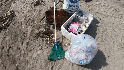 Handheld shot of plastic garbage in bag and box after cleaning on beach, Bali Stock Footage 140290680