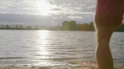 Handheld shot of playful friends enjoying in river against cloudy sky Stock Footage