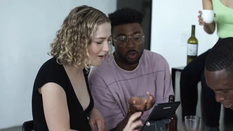 Handheld shot of playful friends using digital tablet Video stock 114866311