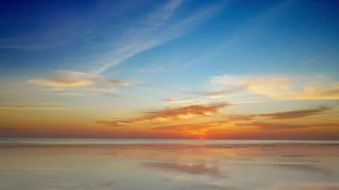 Handheld Shot of Post-Sunset Coastal Glow Ambient Reflections and Golden Haze Stock Footage 312920762