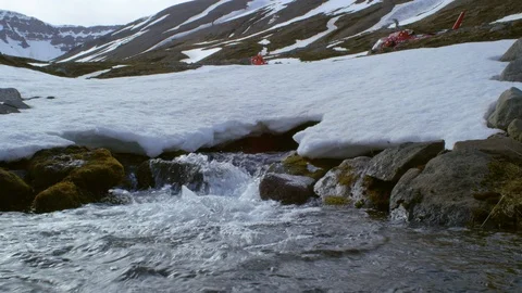 Handheld shot of pro skier stopping in front of small stream of water, Iceland Stock Footage 124228635