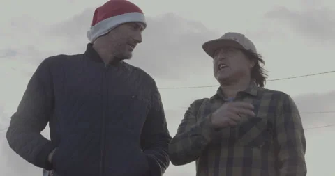 Handheld shot of pro surfer David Langer talking to surfer Ross Clarke-Jones Stock Footage 160112103