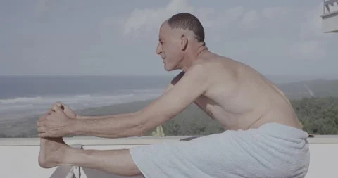Handheld shot of pro surfer David Langer stretching outside on sunny day Stock Footage 160117737