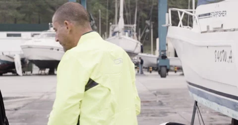 Handheld shot of pro surfer David Langer talking to other surfers outside Stock Footage 160523761