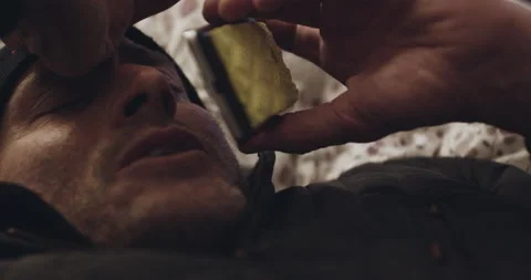 Handheld shot of pro surfer David Langer laying down and talking into phone Stock Footage 160551958