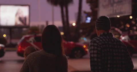 Handheld shot of pro surfer Garrett McNamara in streets with Nicole McNamara Stock Footage 157161109