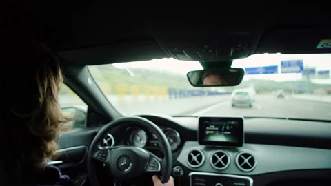 Handheld shot of pro surfer Hugo Vau driving car while talking to Ines Vau Stock Footage 155006493