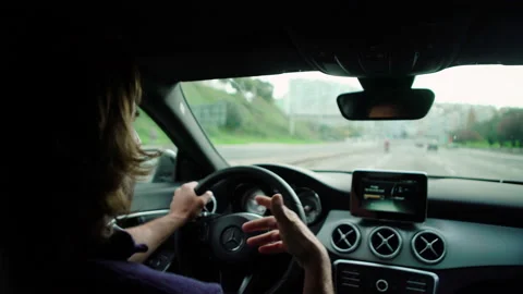Handheld shot of pro surfer Hugo Vau talking to Ines Vau while driving car Stock Footage 155007296