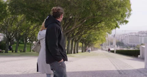 Handheld shot of pro surfer Hugo Vau walking around Lisbon with Ines Vau Stock Footage 155017072
