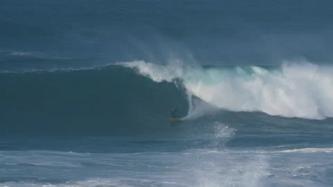 Handheld shot of pro surfer Kohl Christensen riding big wave in Portugal Stock Footage 149924977