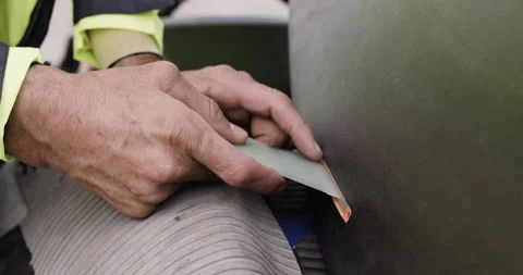 Handheld shot of professional surfer David Langer adjusting fins on surfboard Stock Footage 160520769