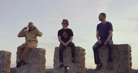 Handheld shot of professional surfers posing for funny picture on Obidos wall Video stock 157161660