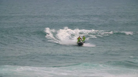 Handheld shot of professional surfers using jet ski to go around atlantic ocean Stock Footage 158651820