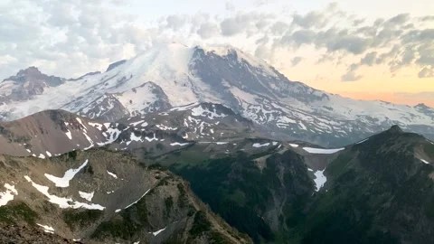 Handheld shot of puffy clouds over Mount Rainier during sunset Stock Footage 169981457