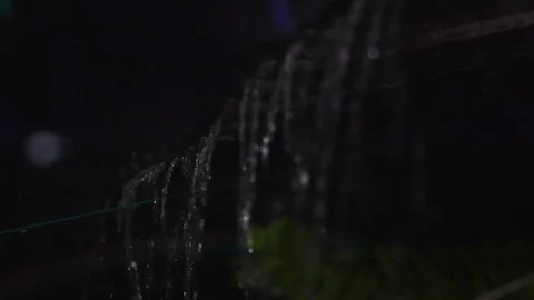 Handheld shot of rain falling off grooves in the roof. Stock Footage 94334610