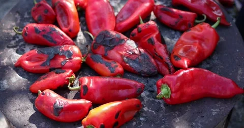 Handheld shot of red peppers while baking for ajvar. Process of making ajvar. Cl Stock Footage 207723965