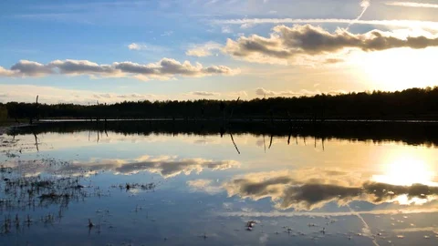 Handheld shot of reflection of clouds falling In water during sunset Stock Footage 122519665