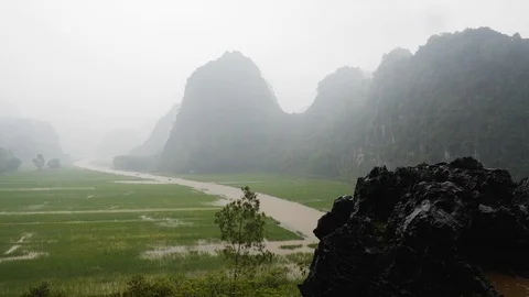 Handheld shot of rice fields close to hang mua peak on rainy day, Vietnam Stock Footage 147356250