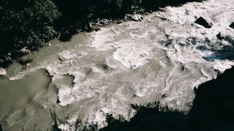 Handheld shot of river flowing through the green forest Stock Footage 122518737