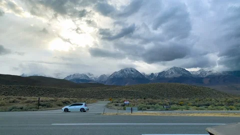 Handheld shot of road passing under mountain range, Lake Tahoe, Sierra Nevada Stock Footage 137945544