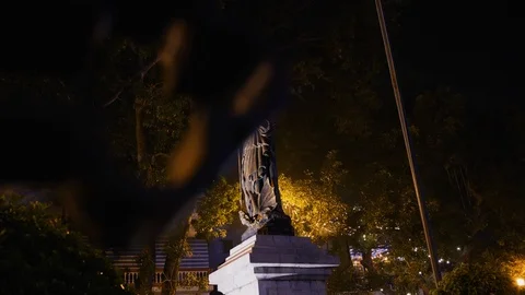 Handheld shot of Saint Joseph statue lit up with outdoor lights in hanoi Stock Footage 147368470