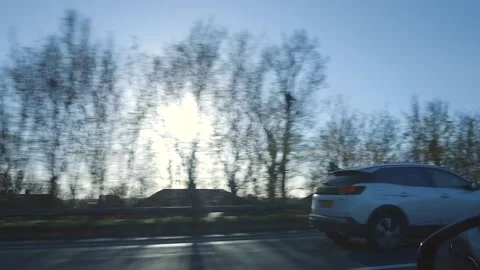 A handheld shot of the side of the road as the car drives by Stock Footage 151016186