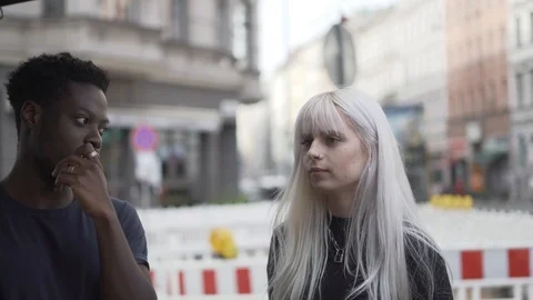 Handheld shot of smiling friends talking in city Stock Footage 120425574