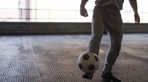 Handheld shot of soccer freestyle player doing tricks with the football Stock Footage