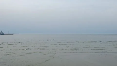 Handheld shot of soft waves near the shore Stock Footage 279660149