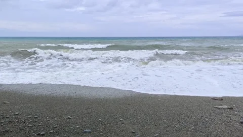 Handheld shot of stormy waves crashing onto the beach in the Philippines Stock Footage 313526112